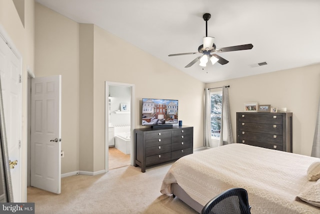 bedroom with ensuite bathroom, ceiling fan, light carpet, and high vaulted ceiling