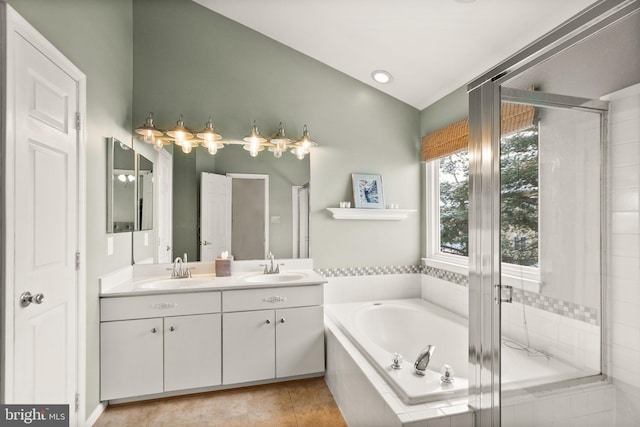 bathroom with vanity, tile patterned flooring, and plus walk in shower