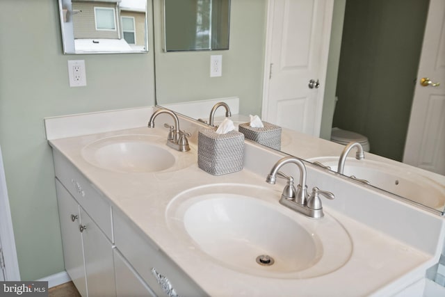 bathroom with toilet and vanity