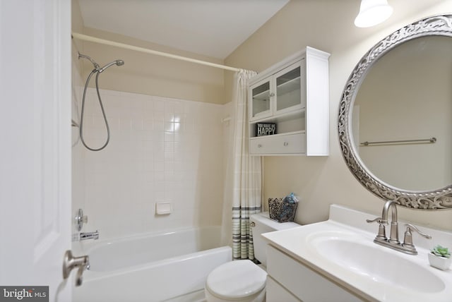 full bathroom with toilet, vanity, and shower / tub combo