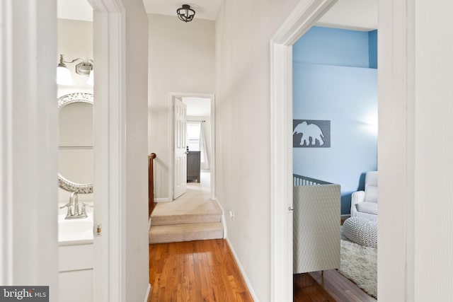 corridor featuring hardwood / wood-style floors and sink