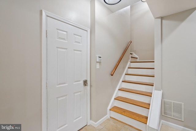 stairway with tile patterned flooring