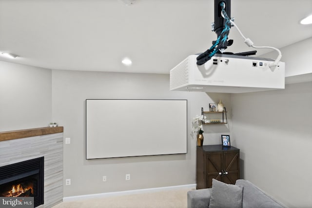 cinema room featuring carpet flooring and a tiled fireplace