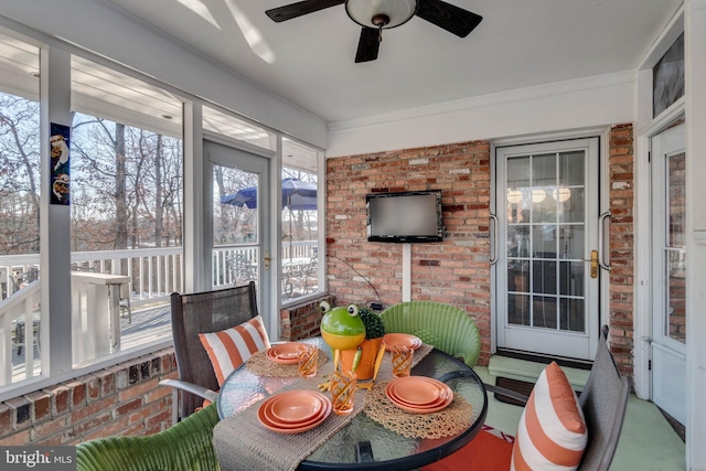 sunroom / solarium featuring ceiling fan