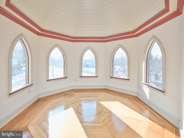 unfurnished room featuring crown molding and a towering ceiling