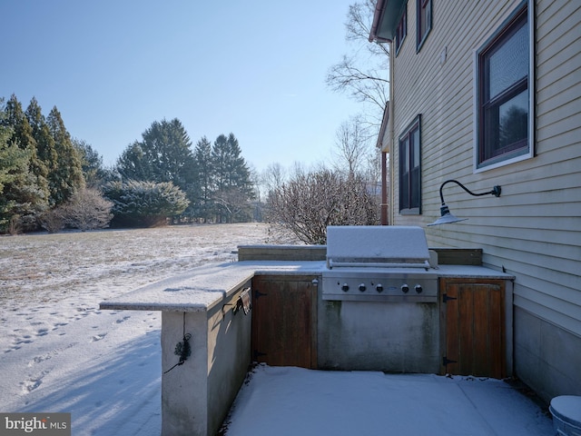 view of patio with exterior kitchen and a grill