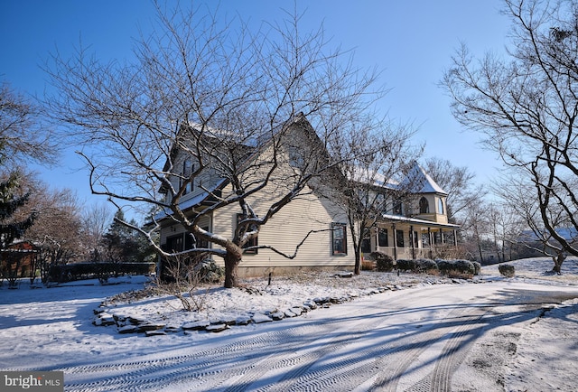 view of snowy exterior with a porch