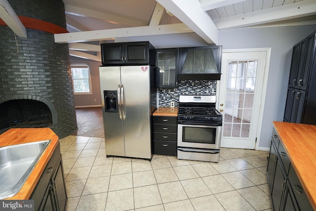 kitchen with stainless steel appliances, custom exhaust hood, butcher block countertops, and beamed ceiling