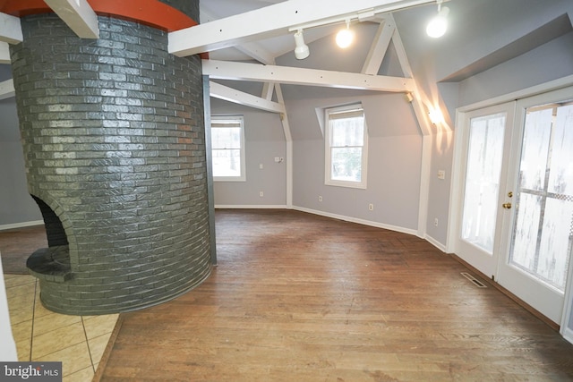 bonus room featuring french doors, lofted ceiling with beams, and hardwood / wood-style floors