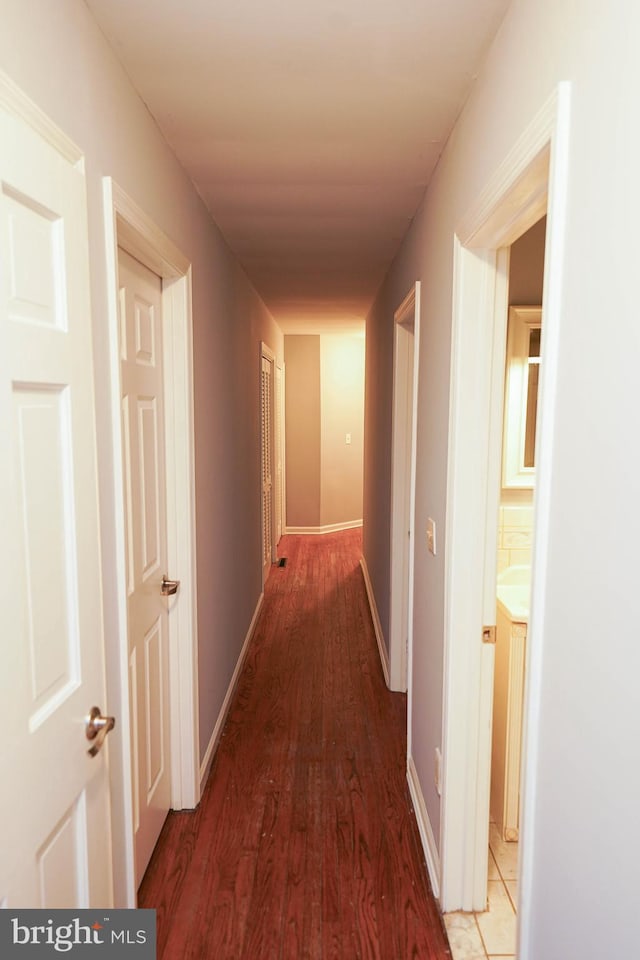 hall with hardwood / wood-style floors