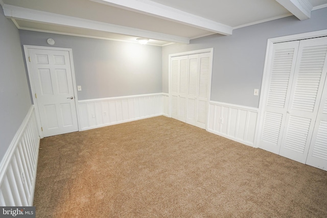 basement featuring ornamental molding and light colored carpet