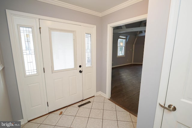 tiled foyer entrance with crown molding