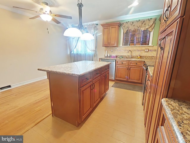 kitchen with a center island, ornamental molding, and dishwasher