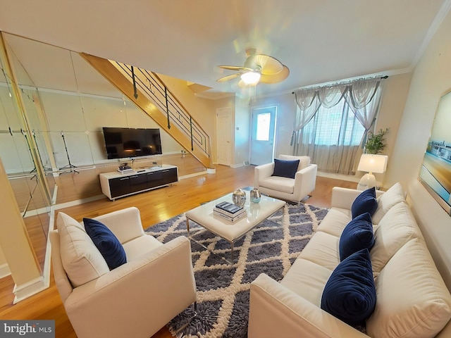 living room with ceiling fan, crown molding, and wood-type flooring