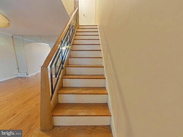 staircase featuring hardwood / wood-style flooring