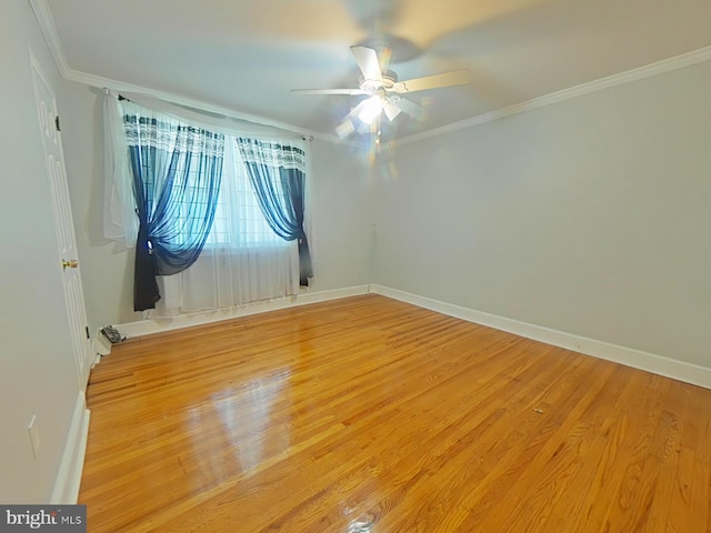 empty room featuring crown molding, wood-type flooring, and ceiling fan