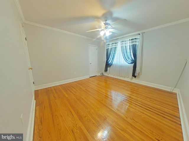 empty room with hardwood / wood-style floors, ornamental molding, and ceiling fan