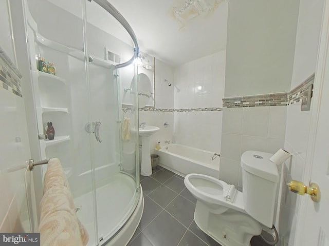 full bathroom with sink, tile walls, separate shower and tub, toilet, and tile patterned floors