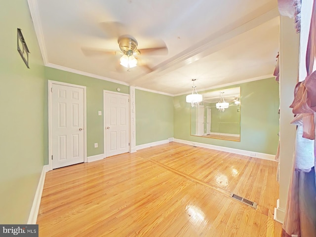 interior space with hardwood / wood-style floors, crown molding, and ceiling fan