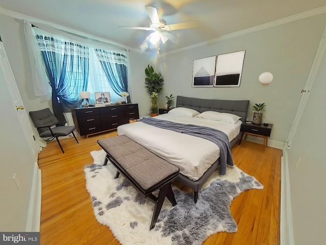 bedroom with ornamental molding, ceiling fan, and light wood-type flooring