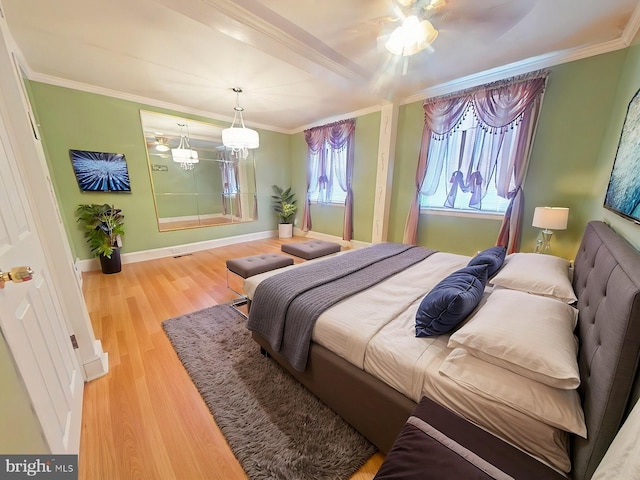 bedroom with crown molding, wood-type flooring, and an inviting chandelier