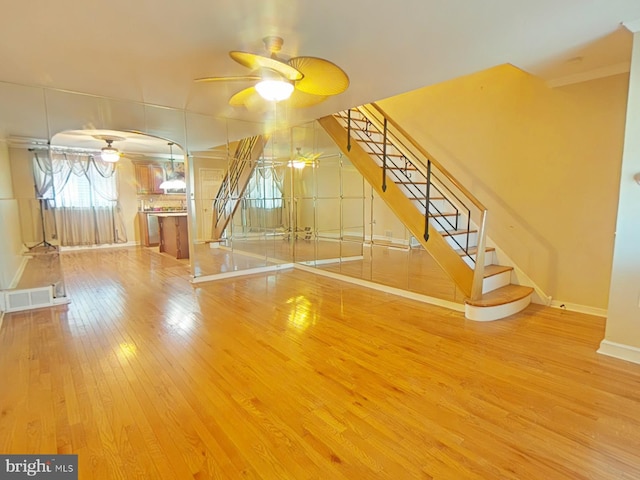 interior space featuring wood-type flooring and ceiling fan