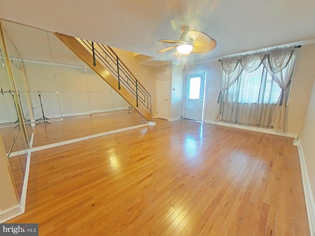 unfurnished living room with hardwood / wood-style flooring and ceiling fan