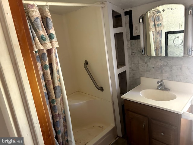 bathroom featuring vanity, decorative backsplash, and a shower with curtain