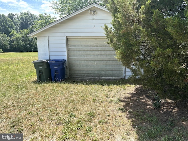 view of home's exterior with a yard and a garage