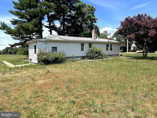 rear view of house featuring a yard