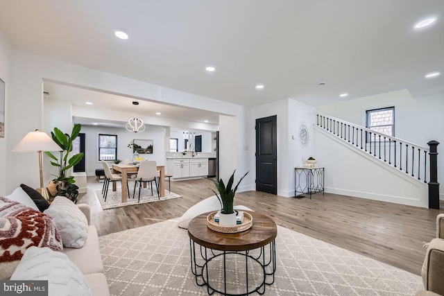 living room with light hardwood / wood-style floors and sink