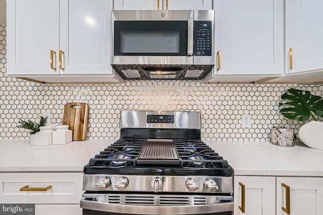 kitchen featuring white cabinetry, stainless steel appliances, and tasteful backsplash