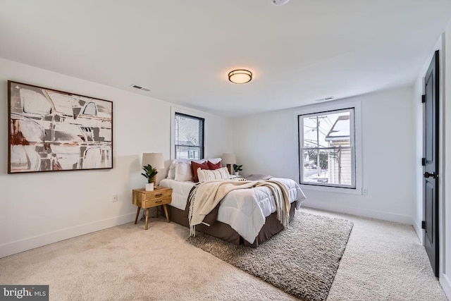 bedroom featuring light colored carpet