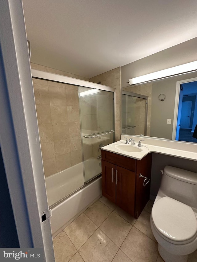 full bathroom with tile patterned flooring, vanity, enclosed tub / shower combo, and toilet