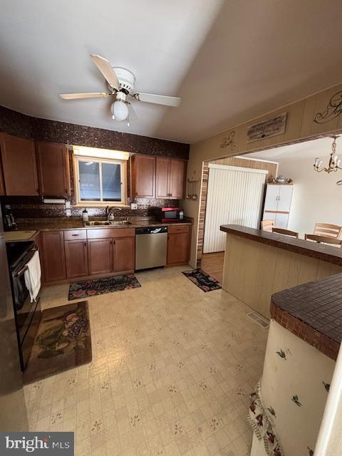 kitchen featuring dishwasher, black range with electric stovetop, sink, and ceiling fan