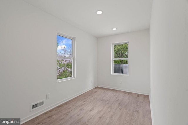 spare room with light hardwood / wood-style floors