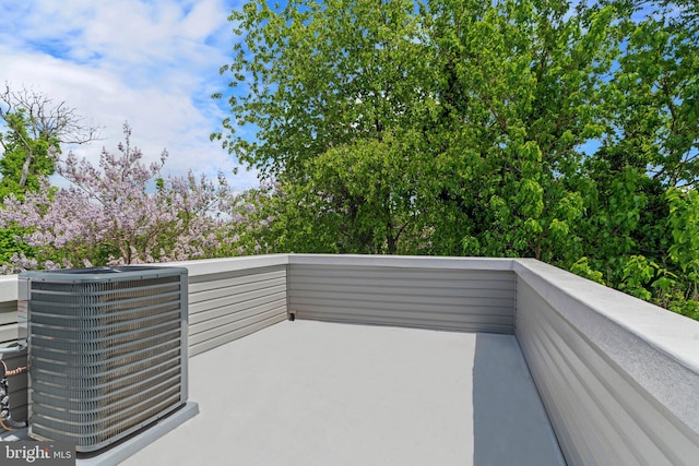 view of patio with cooling unit and a balcony