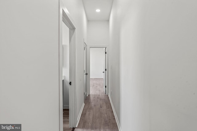 hall with hardwood / wood-style flooring