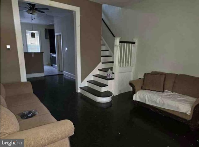 living room featuring ceiling fan and dark wood-type flooring