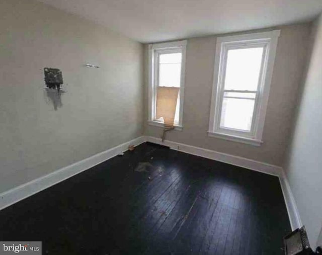 unfurnished room featuring dark hardwood / wood-style flooring