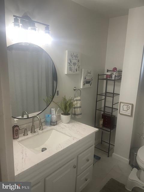 bathroom with toilet and vanity