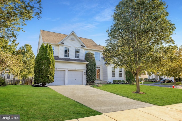 view of front of property with a garage and a front yard