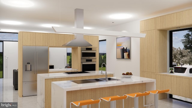 kitchen featuring a kitchen island, light brown cabinets, and appliances with stainless steel finishes