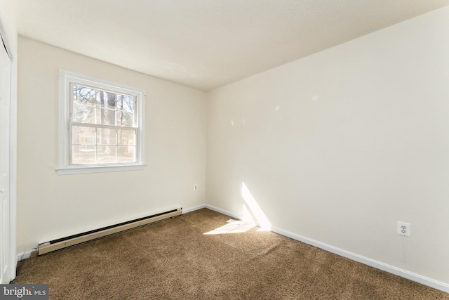 carpeted spare room featuring a baseboard radiator and baseboards