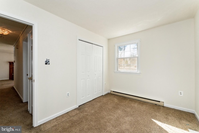 unfurnished bedroom featuring a baseboard radiator, a closet, carpet flooring, and baseboards