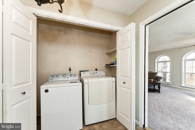 laundry area with carpet floors, laundry area, a textured ceiling, and washing machine and clothes dryer