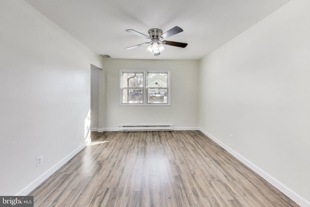 unfurnished room with ceiling fan, a baseboard heating unit, and light wood-type flooring