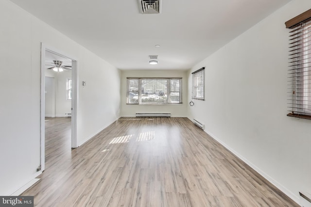 unfurnished living room featuring light hardwood / wood-style flooring and a baseboard radiator