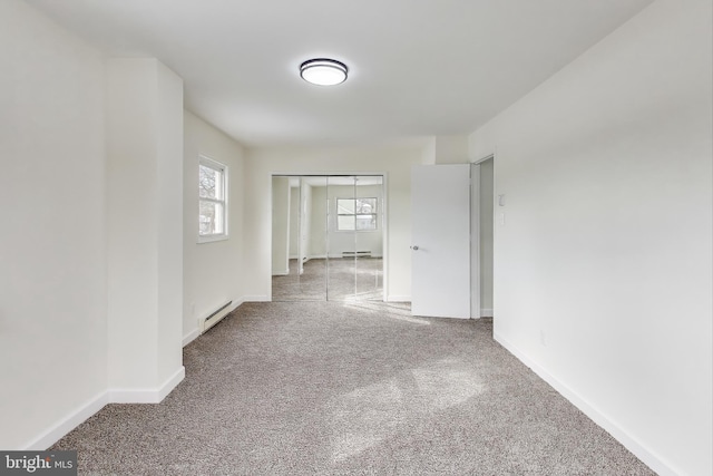 unfurnished room with a baseboard radiator