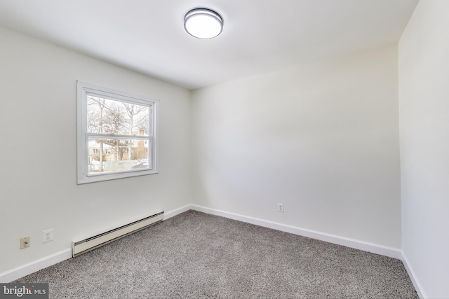 carpeted spare room with baseboard heating